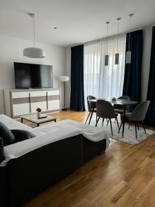 a living room with a bed and a table and chairs at Palm Blues in Vodice +67 photos