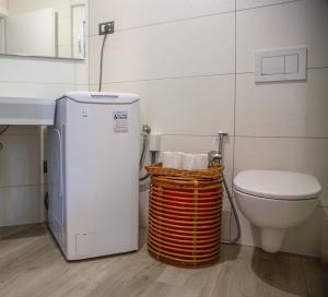 a bathroom with a toilet and a small refrigerator at Sea Point in Celle Ligure +34 photos