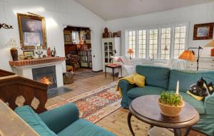 a living room with blue couches and a fireplace at Nice Home In Tørring With Wifi in Lindet