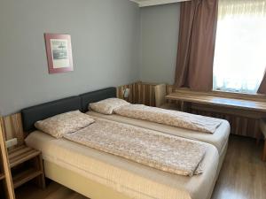 Postel nebo postele na pokoji v ubytování ''Am Limes'' Hotel