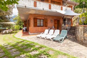 a group of chairs sitting outside of a house at Seaview Camaiore in Camaiore