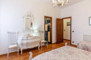 a bedroom with two beds and a dresser and a mirror at Seaview Camaiore in Camaiore +17 photos
