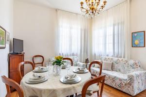 a dining room with a table and a couch at Seaview Camaiore in Camaiore
