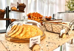 a display of bread and pastries on a table at Les Capucines Saint Tropez in Saint-Tropez