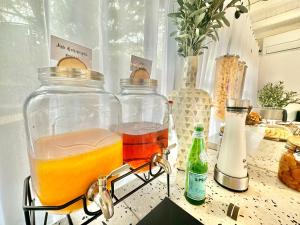 two glass jars filled with liquid sitting on a table at Les Capucines Saint Tropez in Saint-Tropez
