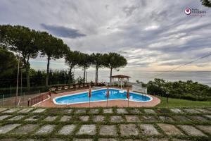 a swimming pool with a gazebo in a yard at Villa Nella - WelcHome in Marina di San Vito