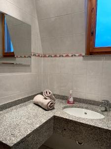 a bathroom counter with a sink and a towel at Villa am Peetzsee in Schlangenluch +21 photos
