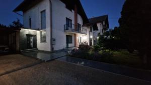 a large white house with its lights on at Apartments & Spa - Insula Vita in Bihać