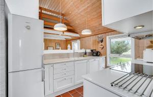 クリムトラにあるHoliday Home Klitstien Thisted Ivの木製の天井、白い家電製品付きのキッチン +18枚の写真