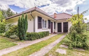 a small white house with black shutters at Lovely Home In Parzensko With Sauna in Karsko