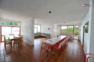 a living room with a table and chairs and windows at Villa Nella - WelcHome in Marina di San Vito +25 photos