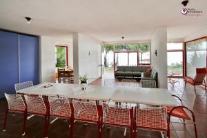 a living room with a table and chairs at Villa Nella - WelcHome in Marina di San Vito