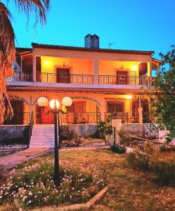 a large house with a street light in front of it at Villa Apartment with 3 bedrooms in Polýkastron