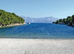 a large body of water with mountains in the background at Holiday Home Aurora in Splitska