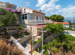 a house with a cross in front of it at Holiday Home Aurora in Splitska