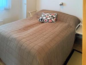 a large bed with a brown comforter in a bedroom at Holiday Apartment Hirvas 1 in Saariselka