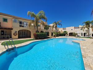 a large swimming pool in front of a house at Las Casitas de la Playa in Vera