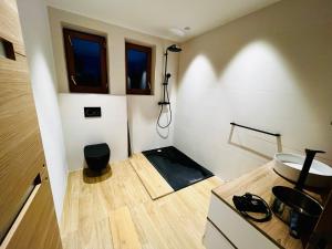 a small bathroom with a sink and a toilet at Villa du Lys Bagnères de Luchon in Luchon