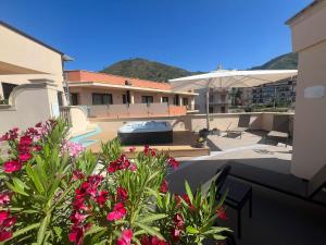 a view of a house with flowers and an umbrella at Artemis Hotel in Cefalù