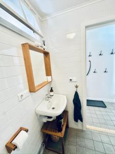 a bathroom with a sink and a mirror at Wisby Residence in Visby +58 photos