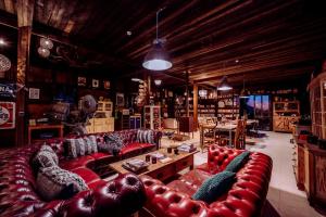 a living room with red leather couches and a table at Ali Baba Infinity in Essaouira