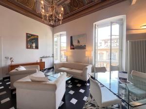 a living room with chairs and a chandelier at WELCOME RIVIERA - Berto's Apartment Luxury 3 bedrooms 2 bathrooms in City Centre in Chiavari
