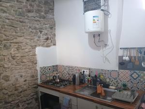 a kitchen with a sink and a stove top oven at High Flyers Kite House in Tarifa +59 photos