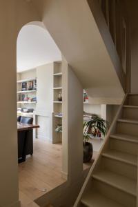 a staircase leading up to a room with a desk at 3 Kings in Bruges
