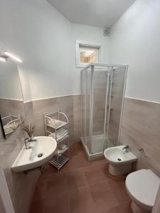a bathroom with a shower and two sinks and a toilet at B&B Villa Machi in Paola +31 photos