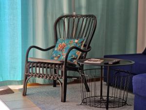 a chair with a pillow sitting next to a table at 7 LAKES apartment in Bohinj