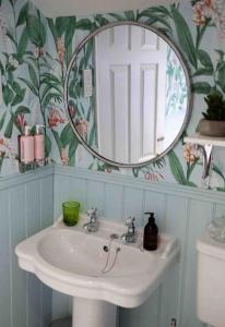 a bathroom with a sink and a mirror at Stunning City centre Georgian townhouse - parking in Chester