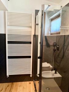 a bathroom with a shower and a toilet and a glass door at Maison Lalla in Pré-Saint-Didier