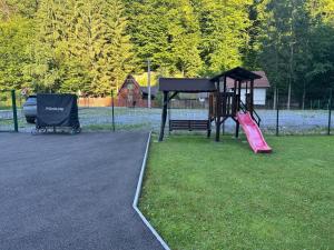 a park with a playground with a slide at Casa Tivoli in Sovata