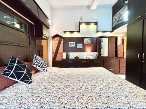 a bedroom with a large bed with two pillows on it at Aristocratic 3BHK apartment near Eastern Metropolitan Club, Santoshpur in Kolkata