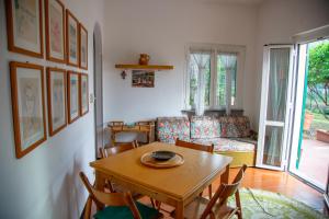 a living room with a table and a couch at Sea Point in Celle Ligure