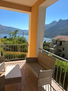a balcony with chairs and a view of the water at Villa Risan Apartments in Risan