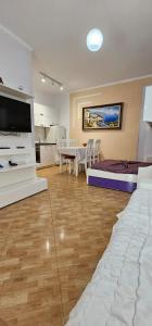 a living room with a kitchen and a dining room at Dori 's place in Vlorë
