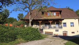 a large white house with a balcony on it at Camping, bring your tent, van or caravan in Granitztal Weißenegg