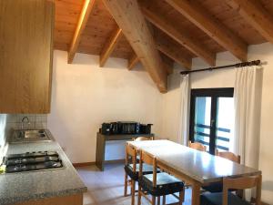 a kitchen with a table and chairs in a room at Casa Felicita in Ledro