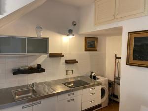 a kitchen with a sink and a microwave at Relax al mare in Giglio Porto