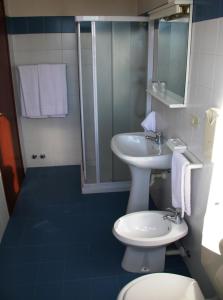 a bathroom with a sink and a toilet and a shower at Hotel Capri in Pasian di Prato