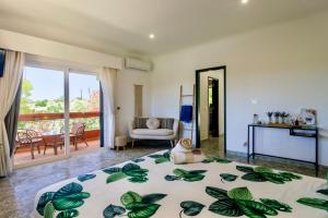 a bedroom with a bed and a living room at Quinta da Falfeira in Lagos