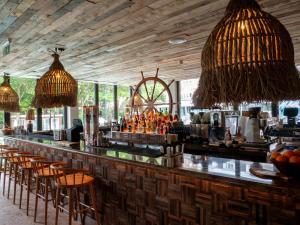 a bar with chairs and a counter with drinks at The Nici in Bournemouth