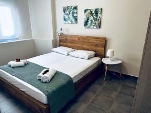 a bedroom with a bed with towels on it at lifeguard beachfront - Luxury Flat, 30meters From Sea in Stalos