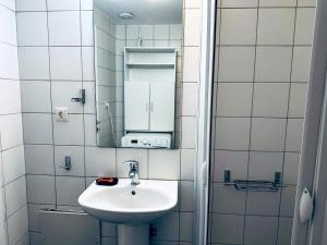 a bathroom with a sink and a mirror at lifeguard beachfront - Luxury Flat, 30meters From Sea in Stalos +35 photos