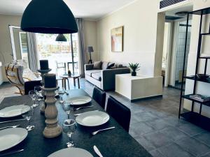 a living room with a dining table and a couch at lifeguard beachfront - Luxury Flat, 30meters From Sea in Stalos
