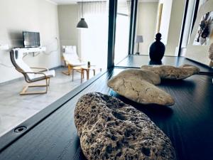 a table with rocks on top of it in a living room at lifeguard beachfront - Luxury Flat, 30meters From Sea in Stalos