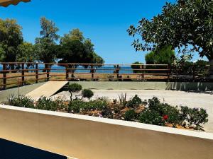 a retaining wall with a garden with a skateboard ramp at lifeguard beachfront - Luxury Flat, 30meters From Sea in Stalos