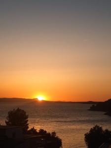 a sunset over the water with the sun setting at Mobile Home L&L in Drage