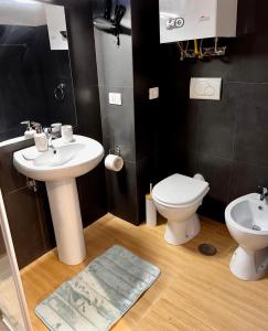 a bathroom with a sink and a toilet at Casa di Nia Pietralata in Rome +14 photos